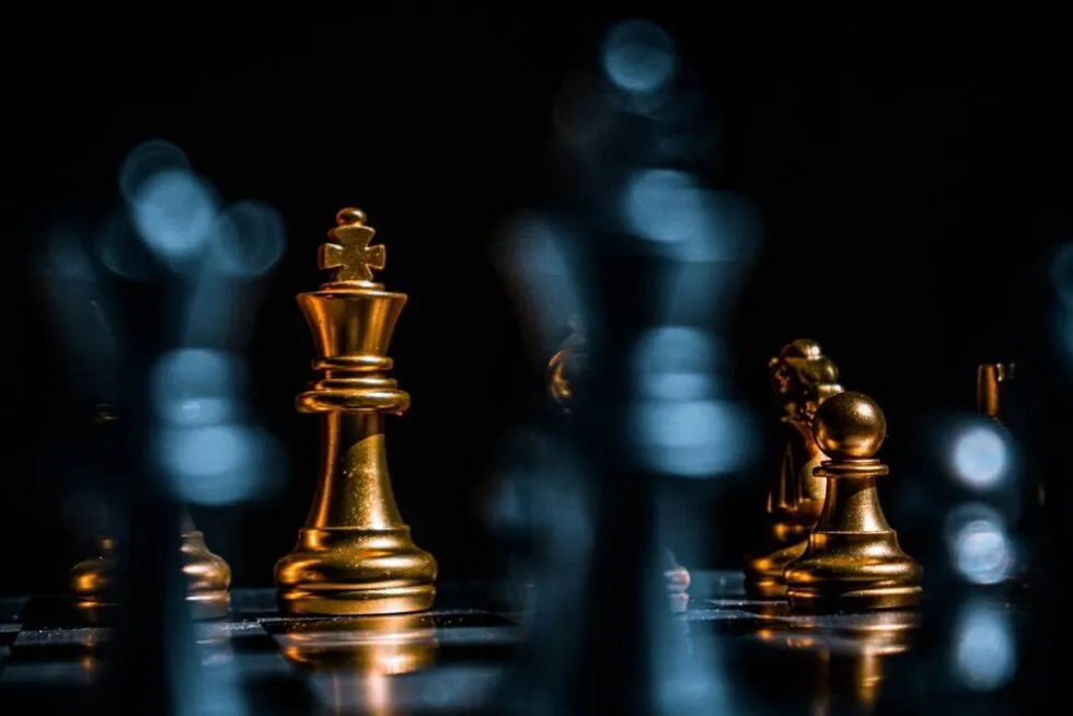 Gold chess pieces on a dark board, for planning a marketing strategy
